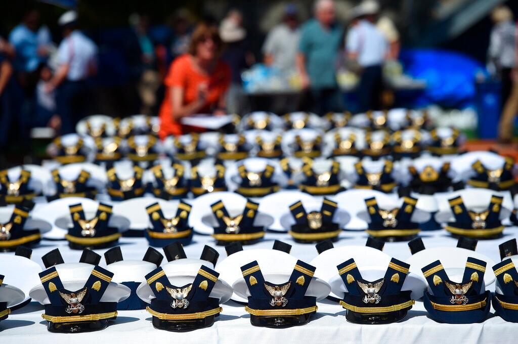 new hats and shoulder bars for the graduates sit on a table before the start of the U.S. Coast Guard Academy's Commencement Exercises