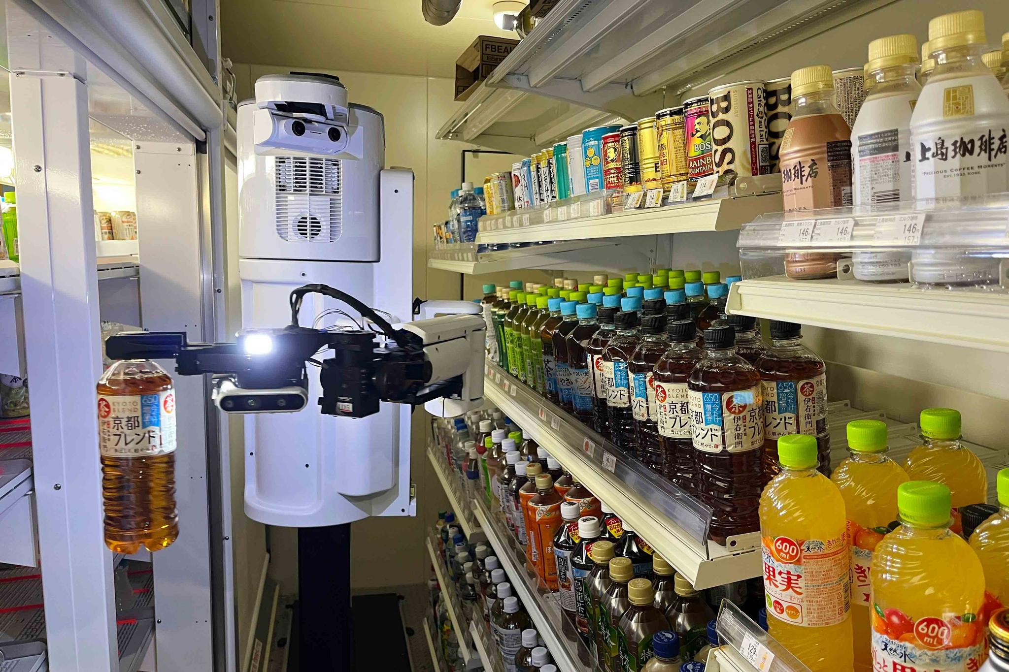TX SCARA robot works, stocking drinks in the refrigerated section of a FamilyMart convenience store in Tokyo, Friday, Aug. 26, 2022.