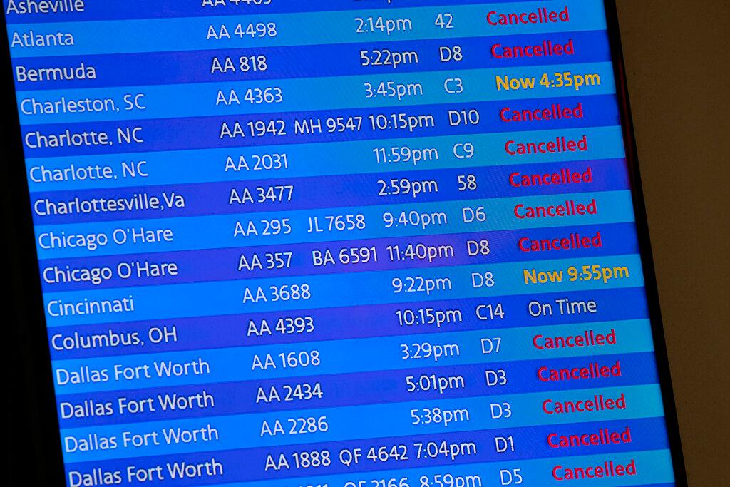 Digital board listing all flights on time or canceled.