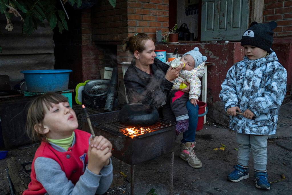Margaryta Tkachenko, 29 years old, feeds her 9-month-old daughter Sophia in the recently retaken town of Izium, Ukraine