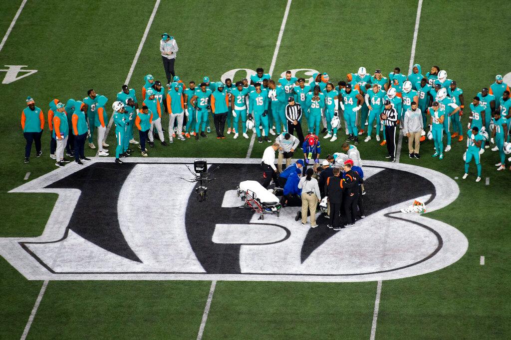 Teammates gather around Miami Dolphins quarterback Tua Tagovailoa after an injury during the first half of an NFL football game