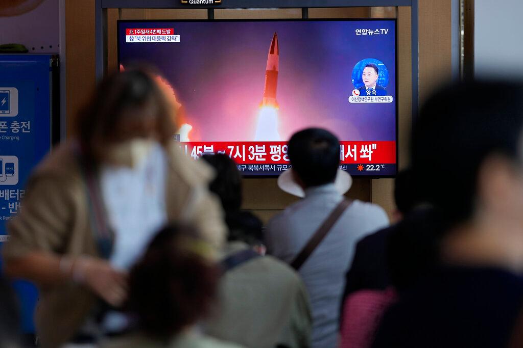 Image of tv screen with people in foreground