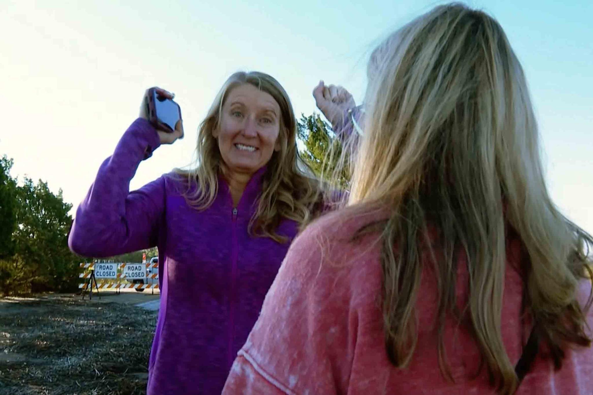 Mary Lord of Ft. Worth, Texas, mother of groom Eric Lord raises her hands hearing the news that some of the bridesmaids’ dresses, tuxedoes are being brought as A.J. McCullough of Sunset Beach, NC, mother of bride Monroe McCullough stands by on Saturday, Oct. 1, 2022 in Pawleys Island, S.C.
