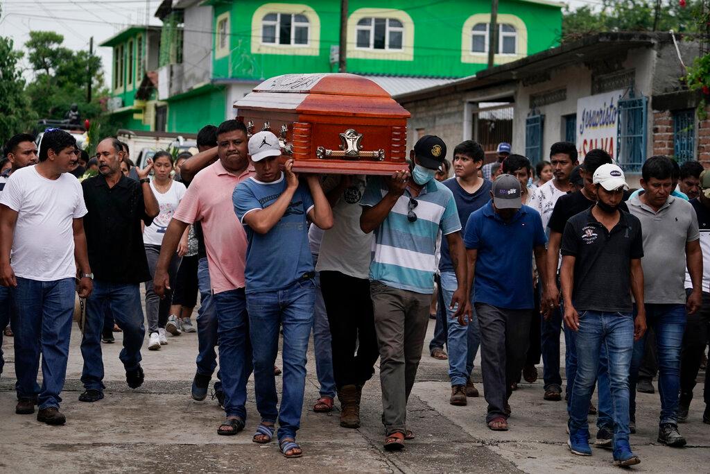 Residents carry a coffin after mass shooting in San Miguel Totolapan, Mexico