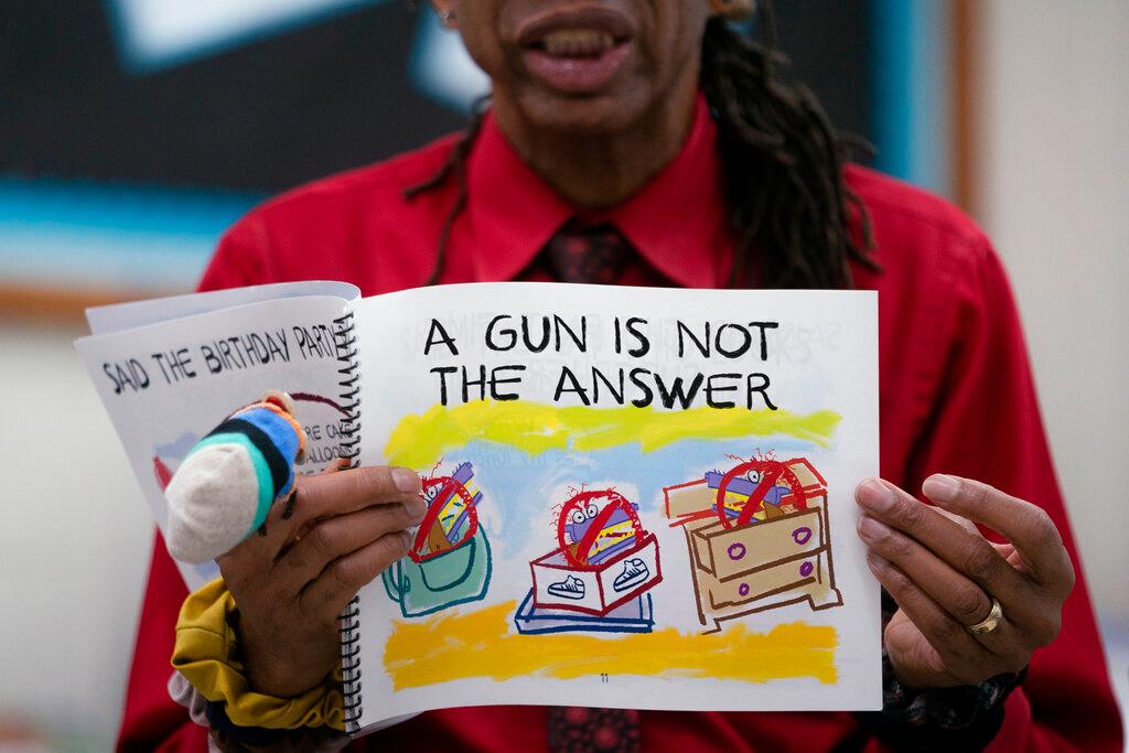 Ian Ellis James, an Emmy award-winning Sesame Street writer known by his stage name William Electric Black, leads a first grade class in a book reading on urban gun violence prevention at the Drexel Avenue School in Westbury, N.Y. 
