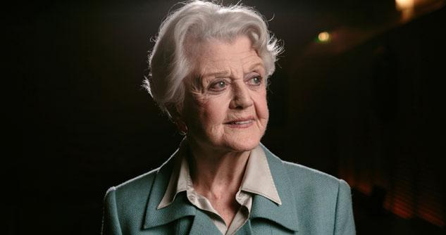 Woman with light green suit, smiling
