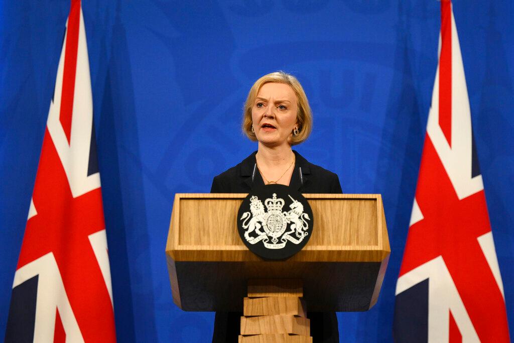 Image of woman speaking in front of podium.