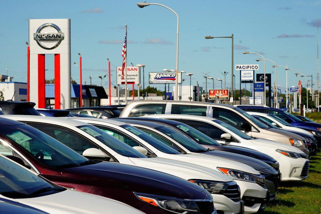Image shows a row of vehicles at dealership.