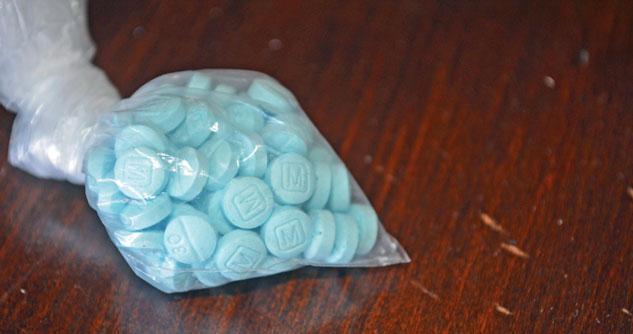 Bag of blue pills designed to look like Rx seized by police in a drug bust. 
