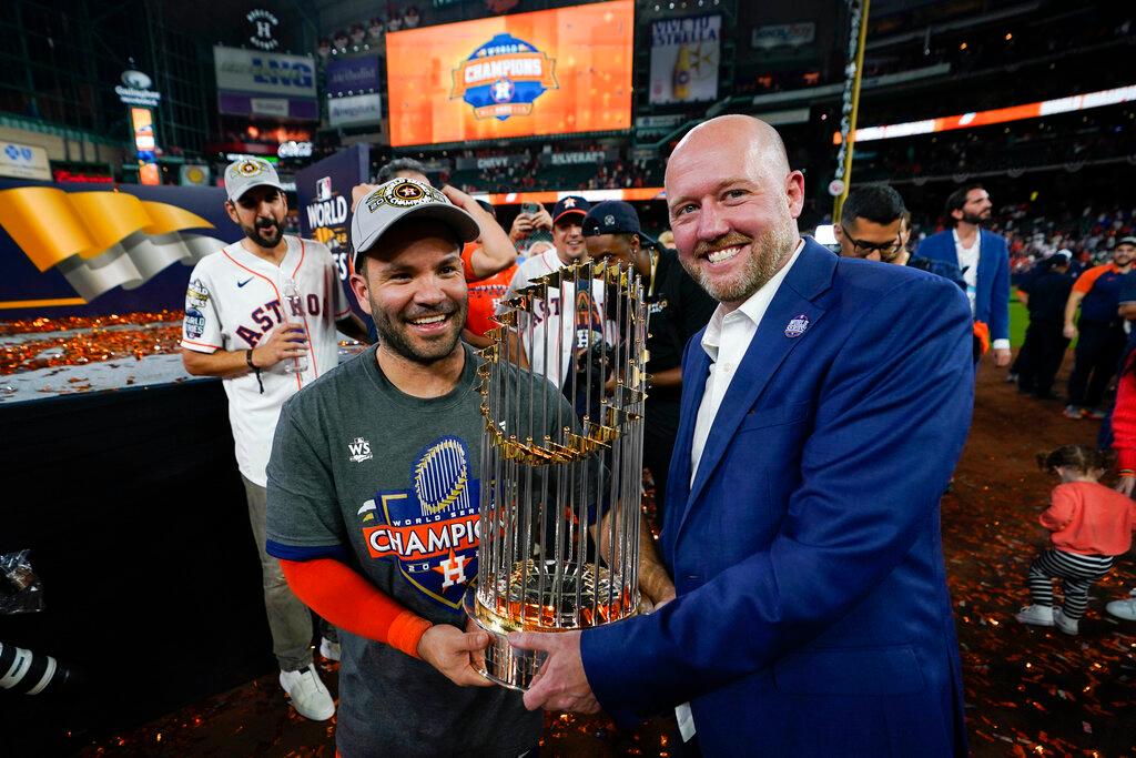 Houston Astros second baseman Jose Altuve and general manager James click celebrate with the trophy after their 4-1 World Series win against the Philadelphia Phillies in Game 6 