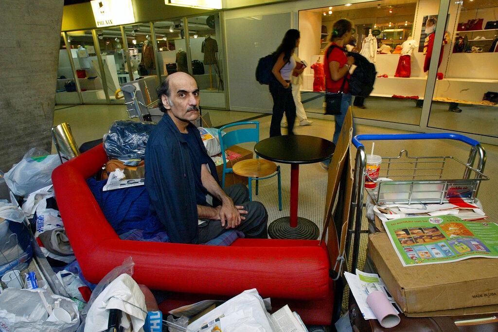  Merhan Karimi Nasseri sits among his belongings at Terminal 1 of Roissy Charles De Gaulle Airport