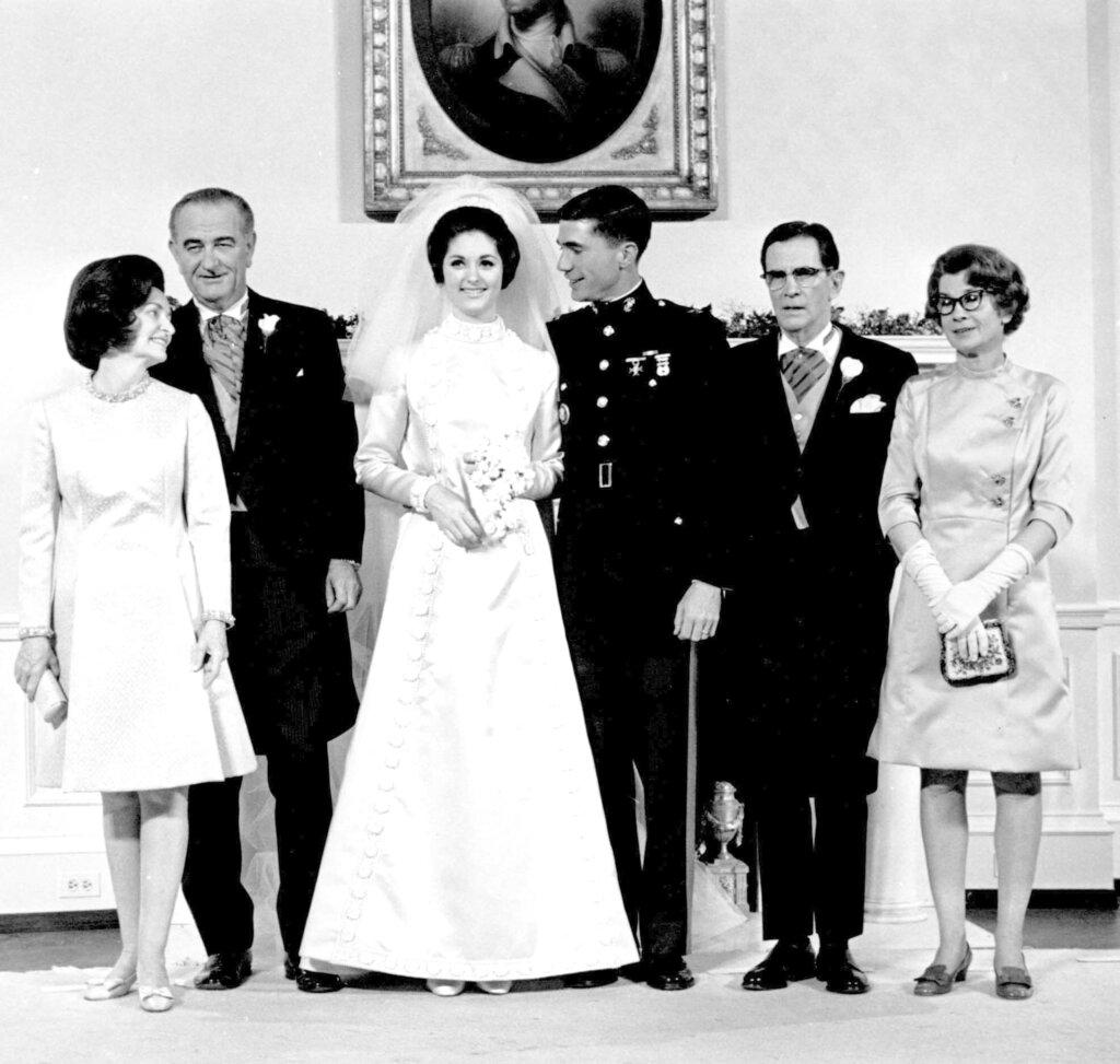 Newlyweds Marine Corps Capt. Charles S. Robb and Lynda Bird Johnson, center, pose for a photo with their parents in the Yellow Oval Room in the White House in Washington on Dec. 9, 1967. Standing from left to right are, first lady Lady Bird Johnson, President Lyndon B. Johnson, the bride-groom, James S. Robb and Frances Robb.