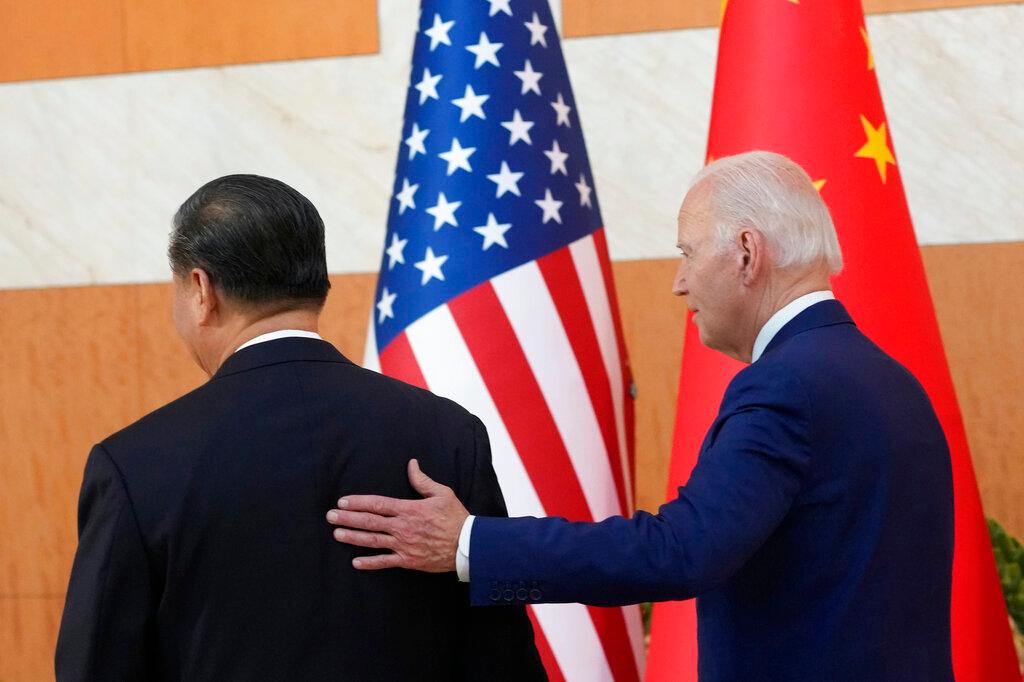 President Joe Biden walks with Chinese President Xi Jinping before their meeting 