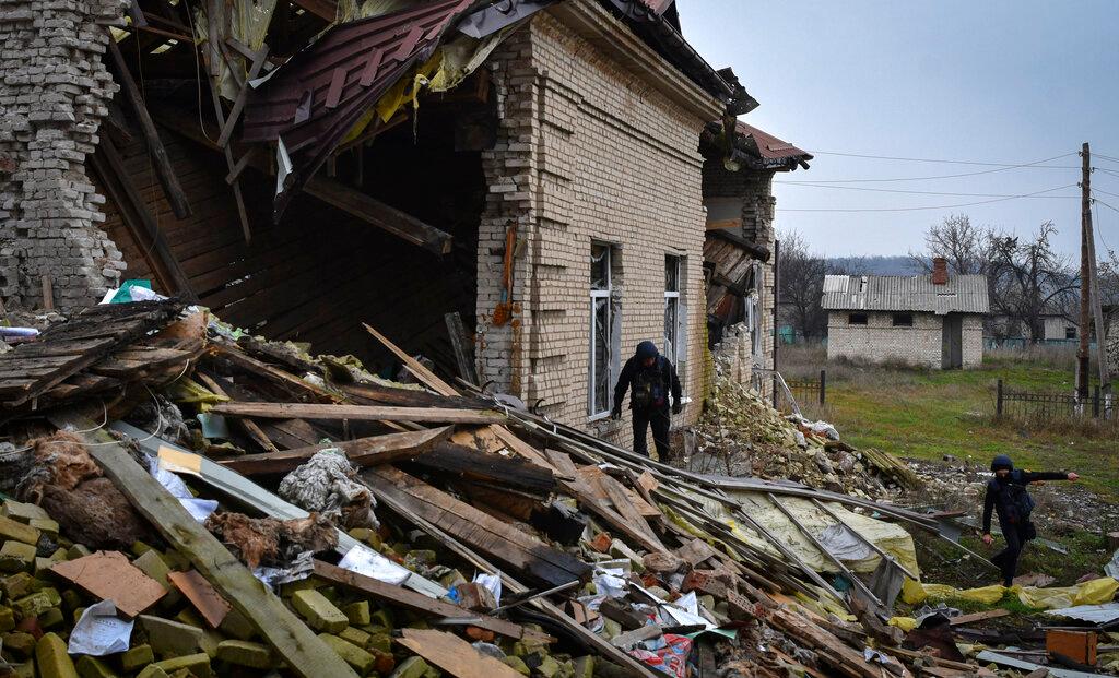 A Ukrainian sapper inspects a destroyed building during the demining of a residential area in Novoselivka, Donetsk region, Ukraine