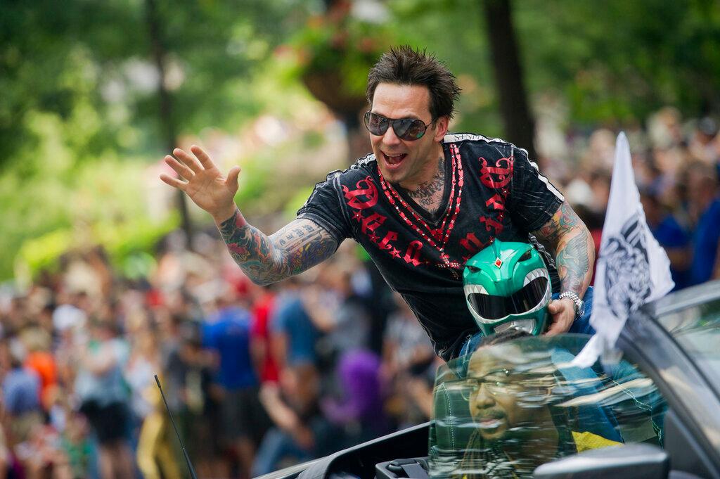 Jason David Frank waves to the crowd as he makes his way down Peachtree Street in the annual DragonCon parade through downtown Atlanta, on Aug. 31, 2013.