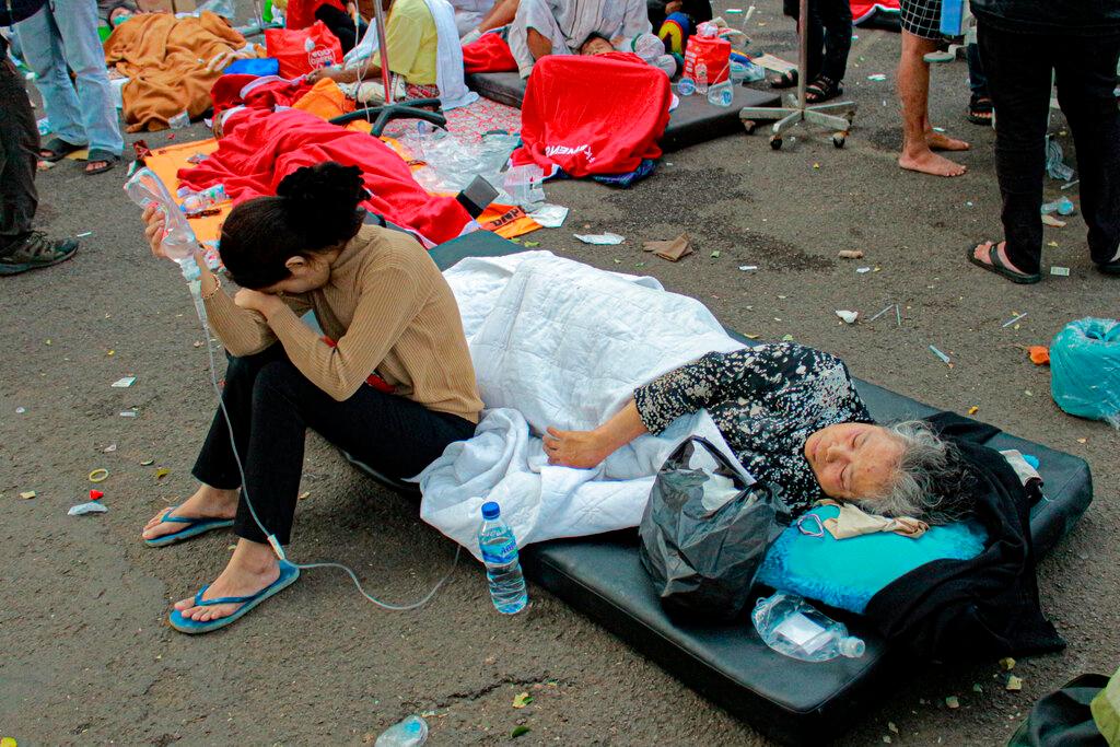 Earthquake survivors are treated outside of a hospital in Cianjur, West Java, Indonesia, Monday, Nov. 21, 2022