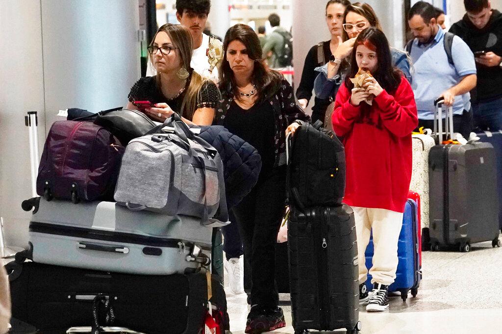 people waiting in line at airport
