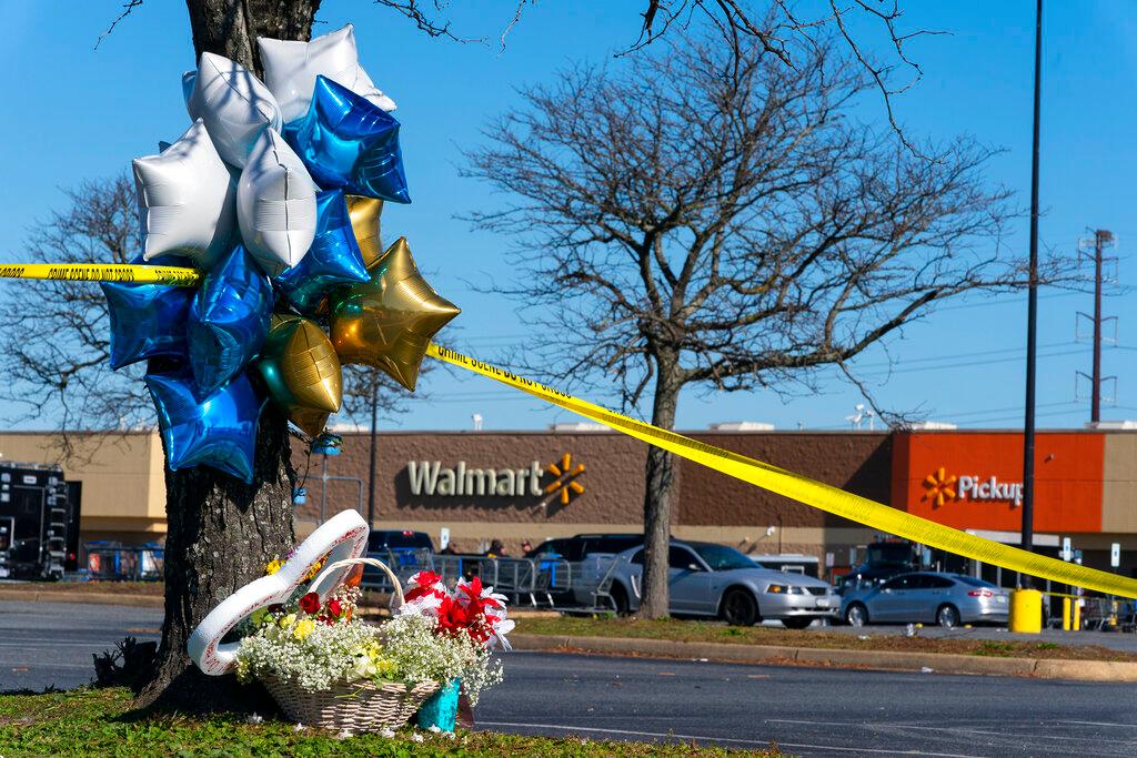 Flowers and balloons have been placed near the scene of a mass shooting at a Walmart, Wednesday, Nov. 23, 2022, in Chesapeake, Va. A Walmart manager opened fire on fellow employees in the break room of the Virginia store, killing several people in the country’s second high-profile mass shooting in four days, police and witnesses said Wednesday.