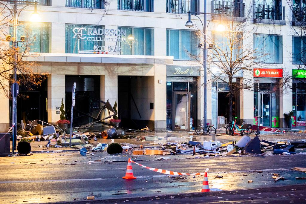 Debris lay on the street after a huge fish tank burst at the Seal Life Aquarium in central Berlin, Germany, Friday, Dec. 16, 2022.