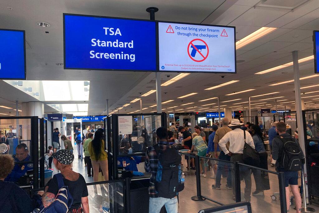 A sign warns travelers not to bring guns through the Transportation Security Administration checkpoint at Orlando International Airport in Orlando