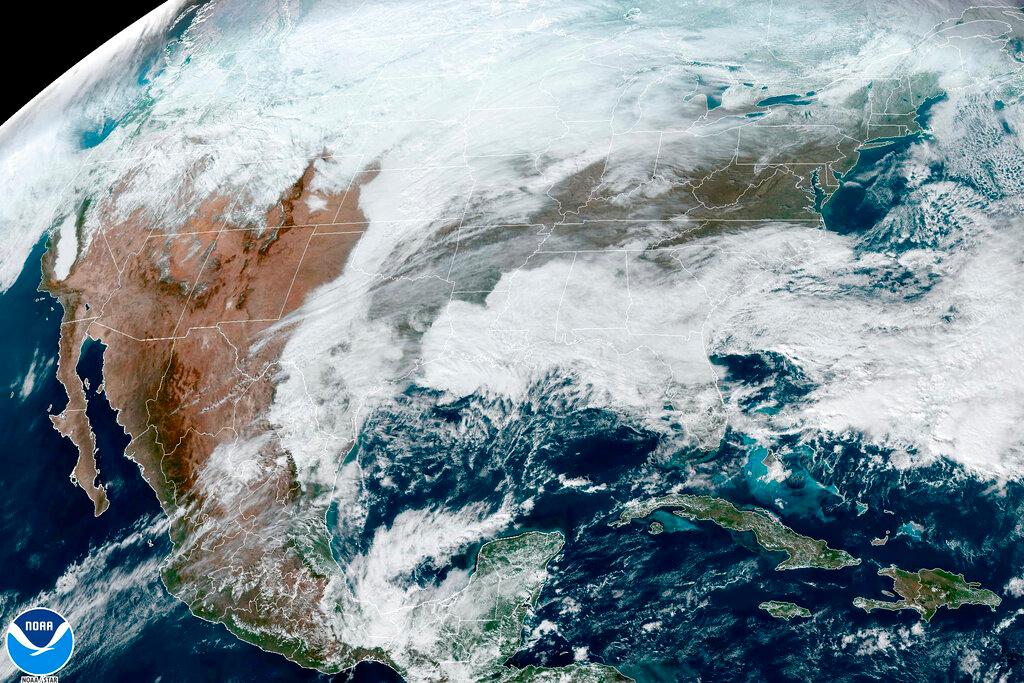 This satellite image made available by NOAA shows cloud cover over North America on Wednesday, Dec. 21, 2022 at 1:31 p.m. An arctic blast is bringing extreme cold, heavy snow and intense wind across much of the U.S. this week — just in time for the holidays.