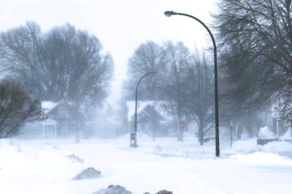 The high wind blows the snow across a neighborhood in Buffalo, N.Y., on Saturday, Dec. 24, 2022 in Buffalo, N.Y. A battering winter storm has knocked out power to 1.7 million homes and businesses across the United States on Saturday. 
