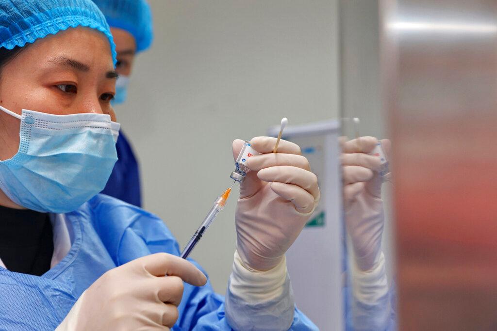 A nurse prepares a shot of COVID-19 vaccine at a community health center in Nantong. 