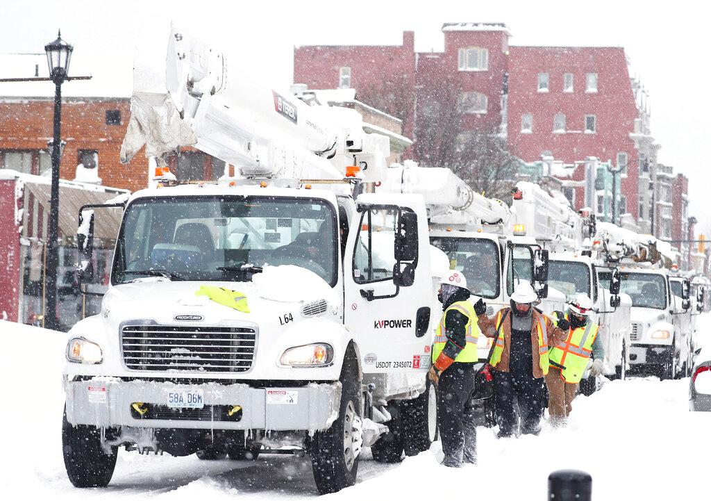 Power line trucks arrive on Allen Street to supply power to apartments and homes in Buffalo, N.Y.