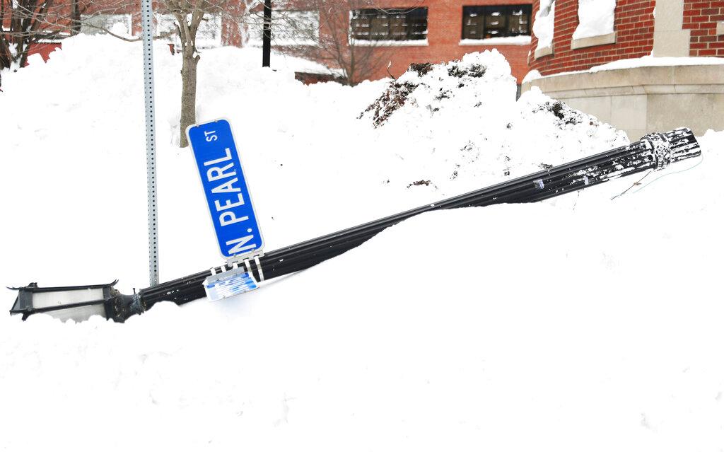 A North Pearl street sign is knocked down following heavy winds in Buffalo, N.Y.