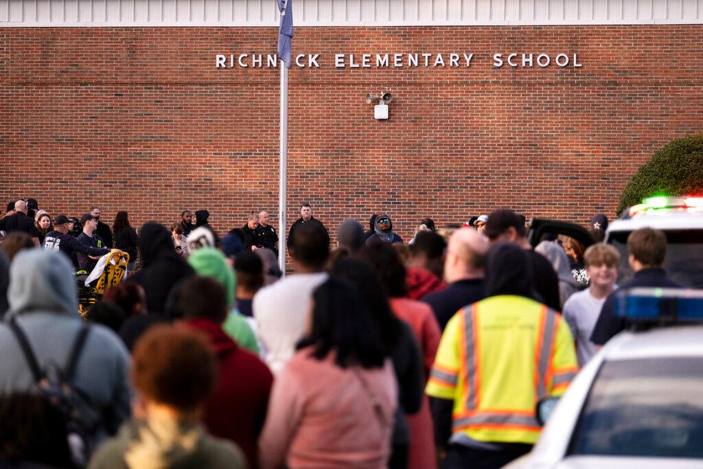 Students and police gather outside of Richneck Elementary School.