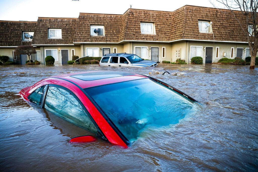 Floodwaters course through a neighborhood in Merced, Calif.