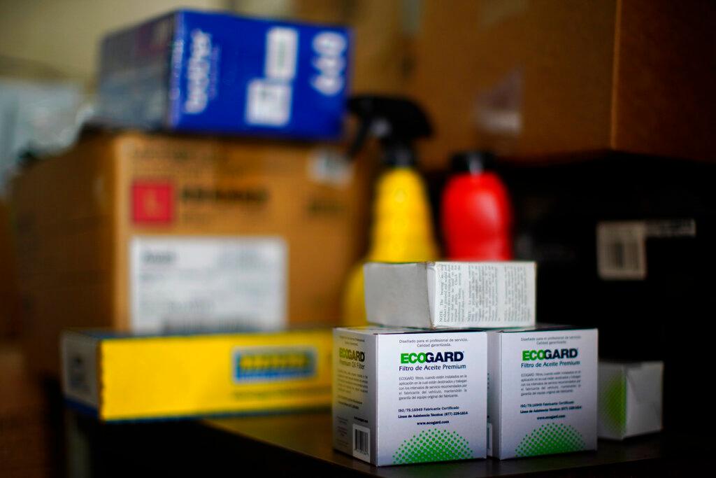 Auto parts are displayed on a shelf at a car repair shop
