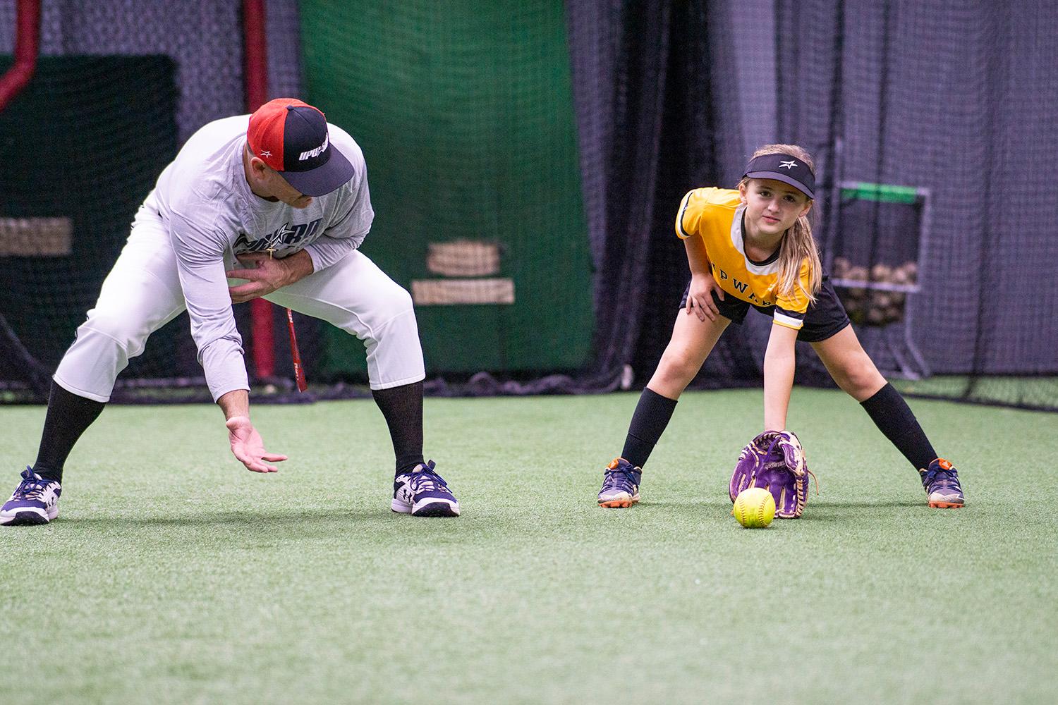Coach training softball player