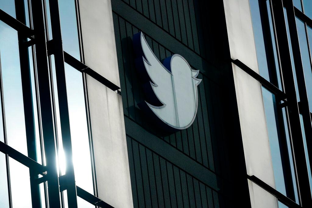 Twitter logo hangs outside the company's offices in San Francisco