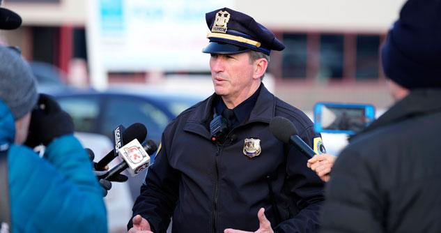 Police officer speaking to reporters