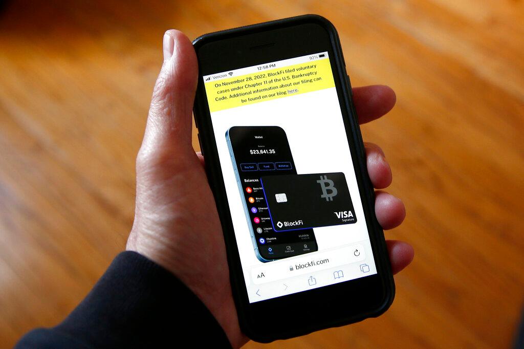 Text, in yellow, announcing cryptocurrency lender BlockFi's bankruptcy filing, appears on the company's website on a smartphone