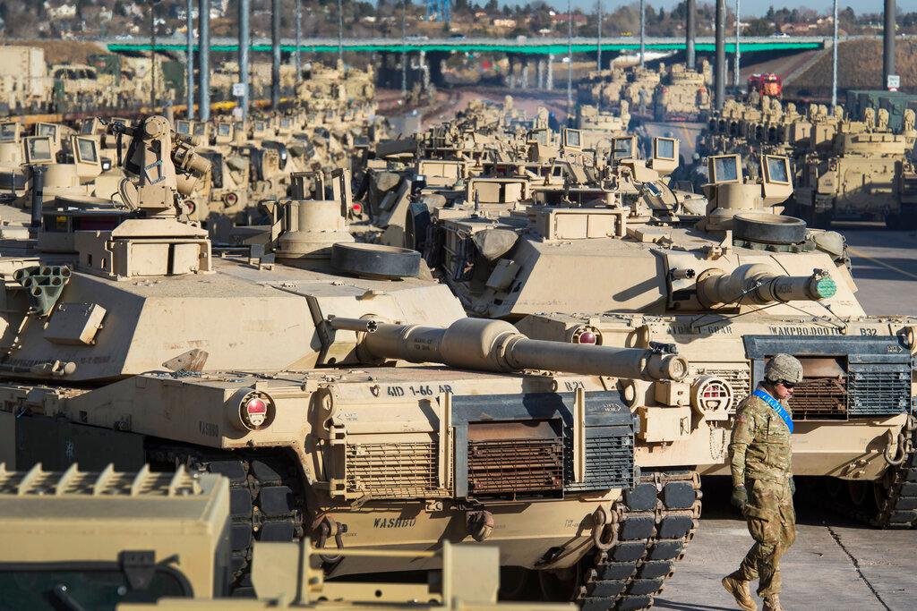 A soldier walks past a line of M1 Abrams tanks at Fort Carson in Colorado Springs, Colo.