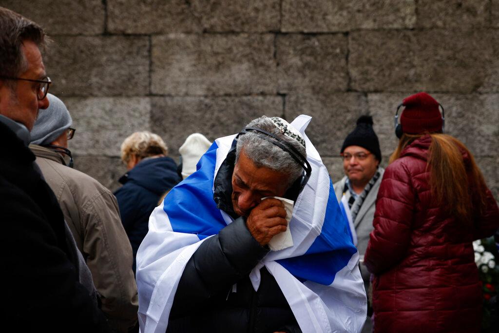  a Yemeni-born Israeli, wipes his tears in front of the Death Wall in the former Nazi German concentration and extermination camp Auschwitz 