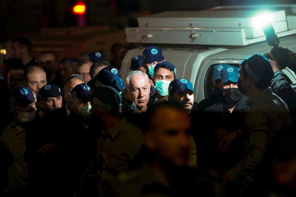 Israeli Prime Minister Benjamin Netanyahu visits the site of a shooting attack near a synagogue in Jerusalem, Friday, Jan. 27, 2023. 