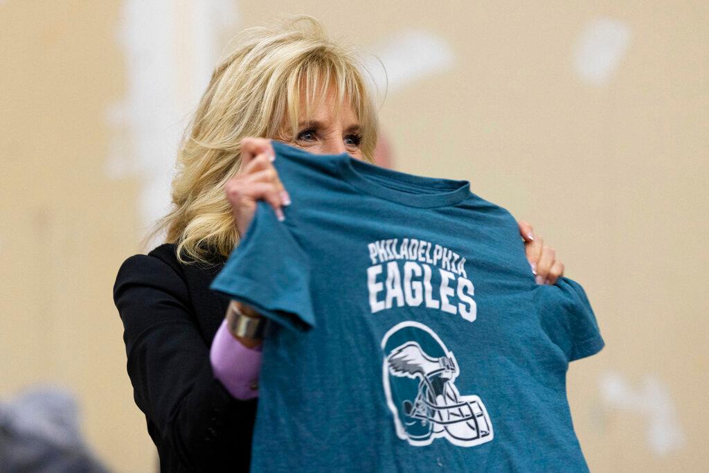First lady Jill Biden holds up a Philadelphia Eagles shirt.