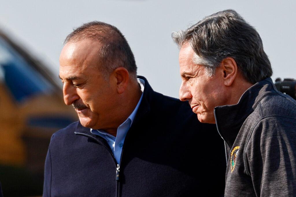 U.S. Secretary of State Antony Blinken is greeted by Turkish Foreign Minister Mevlut Cavusoglu, at Incirlik Air Base near Adana, Turkey, Sunday, Feb. 19, 2023.