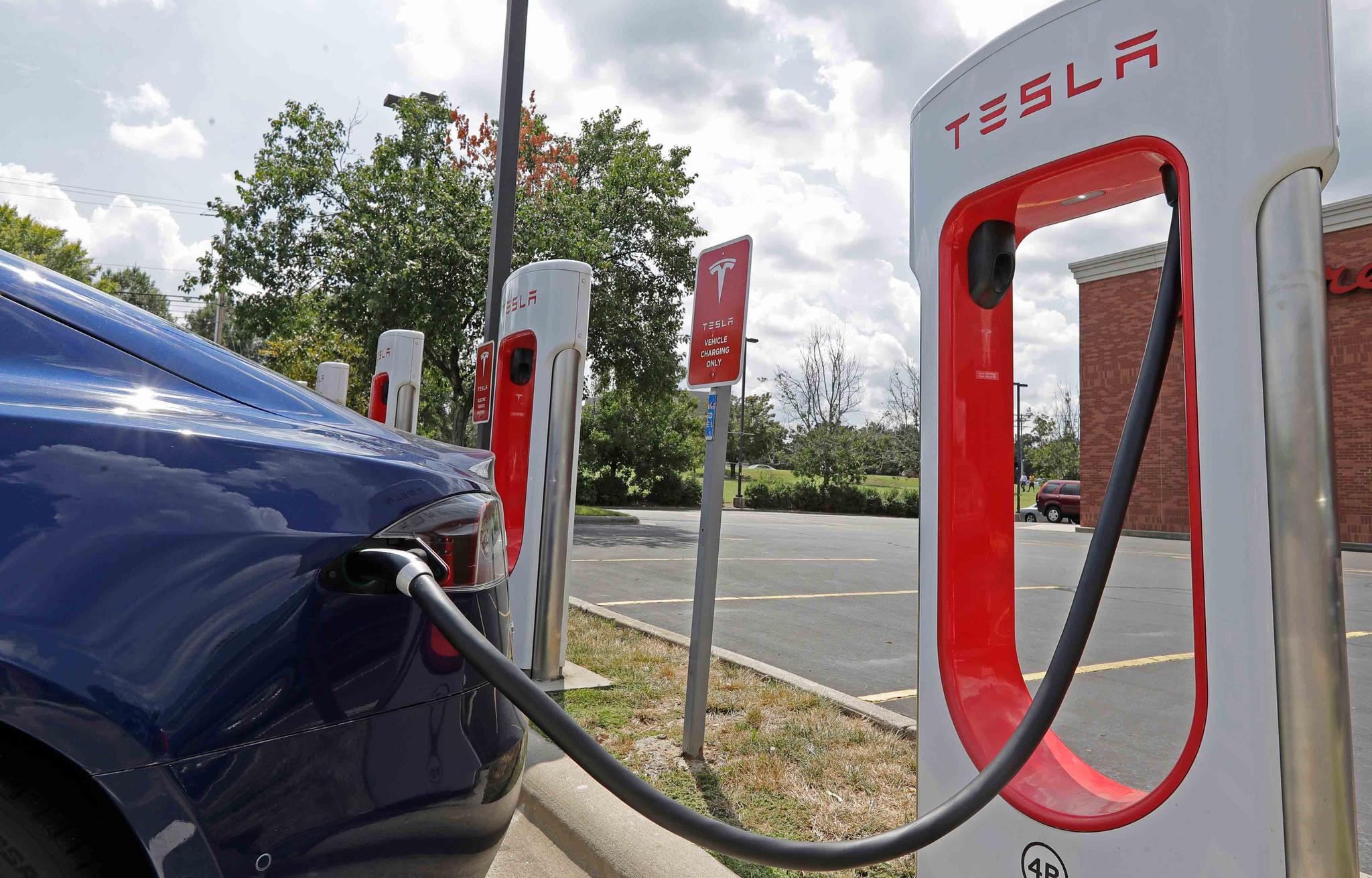 Tesla vehicle charges at a Tesla Supercharger site in Charlotte, N.C.