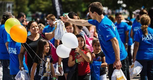 Convoy of Hope volunteers surrounded by women and children