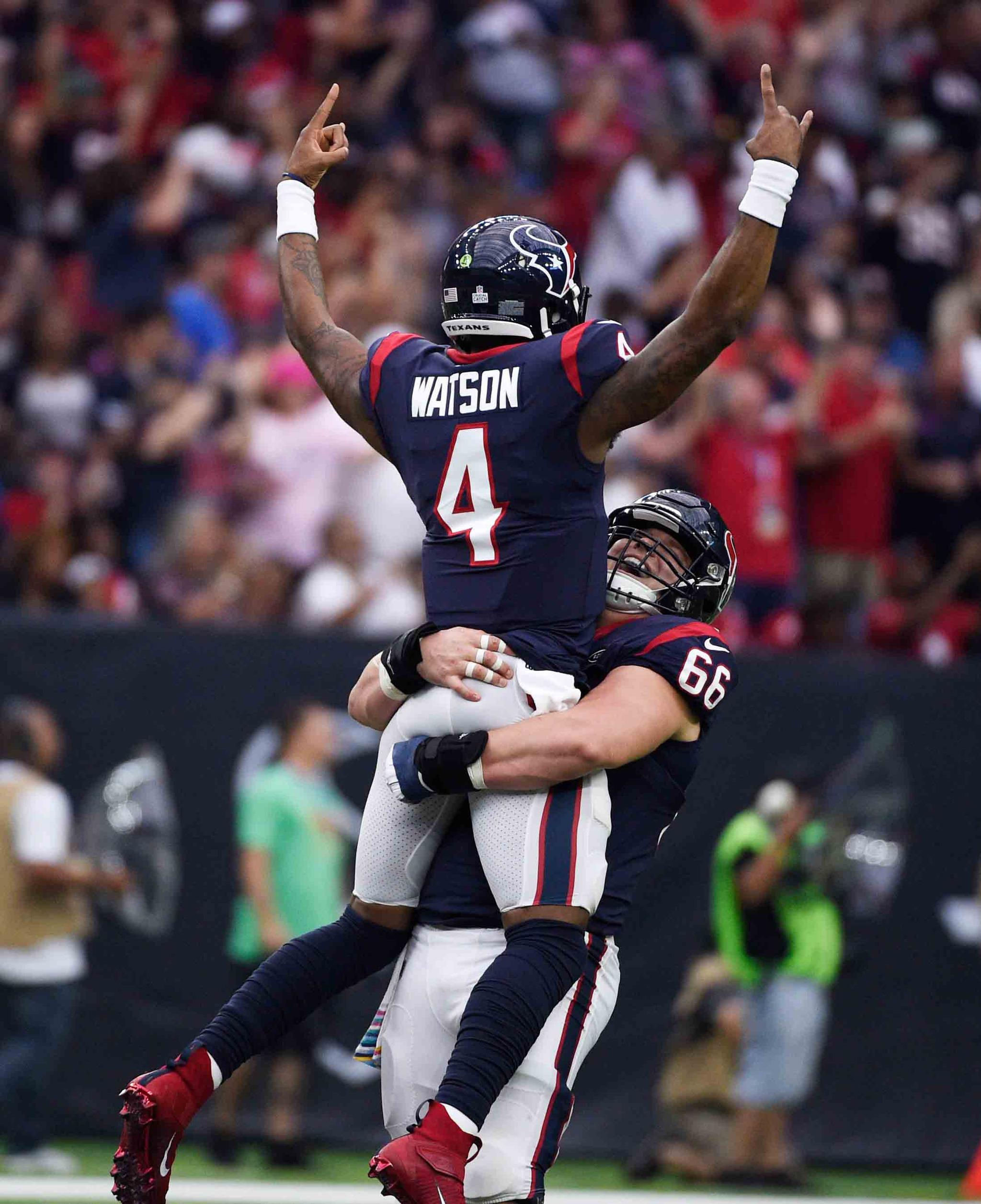 Houston Texans quarterback Deshaun Watson (4) is lifted by teammate Nick Martin (66) as they celebrate a touchdown