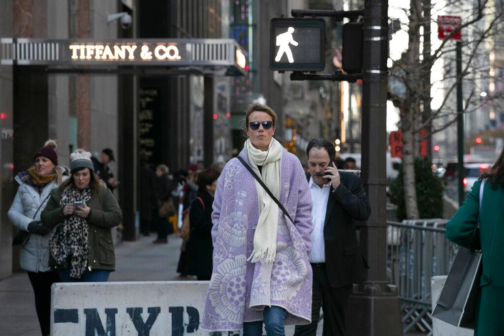 People walk by Tiffany's flagship store