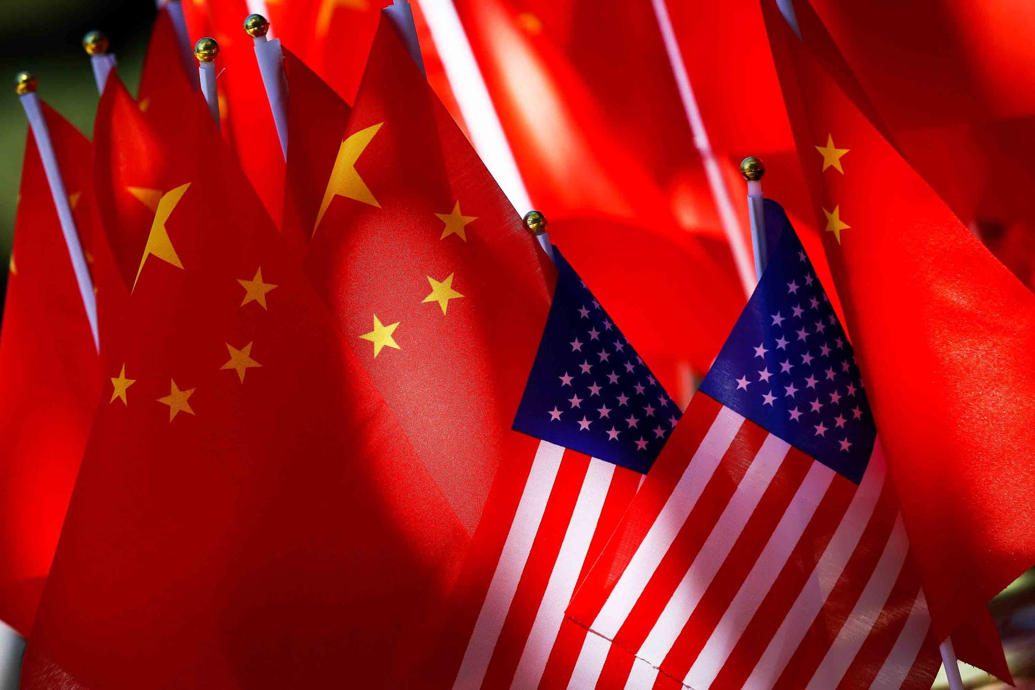 American flags are displayed together with Chinese flags on top of a trishaw in Beijing