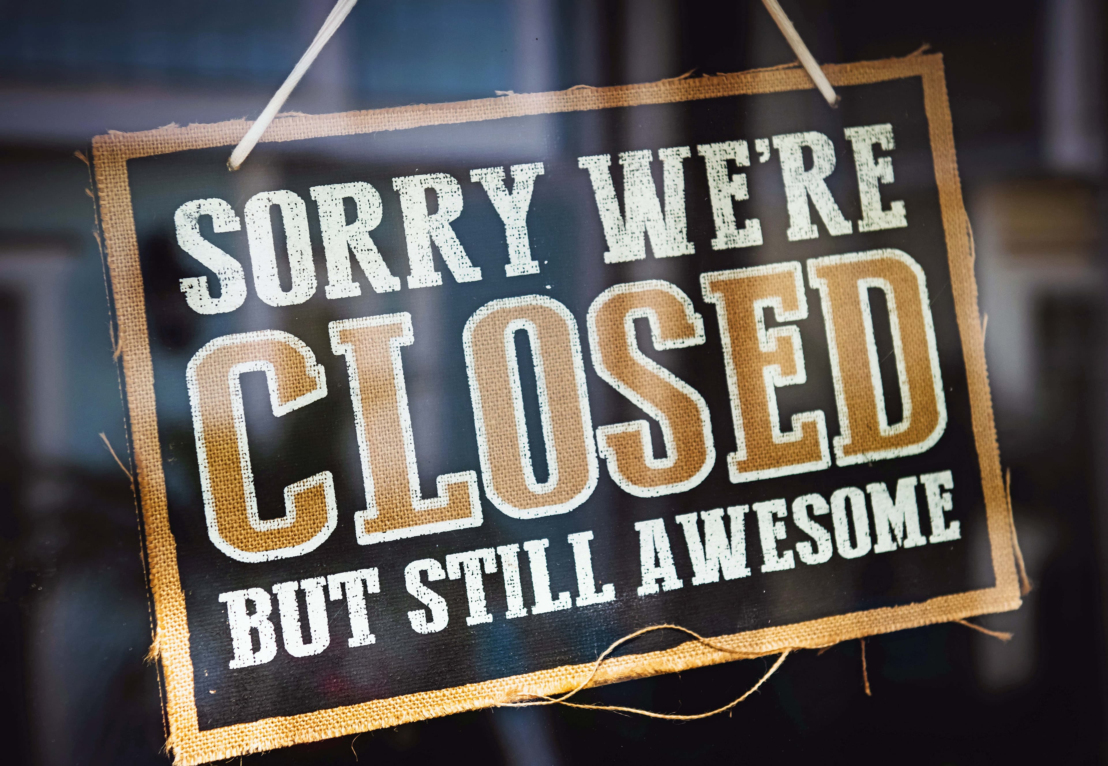 Sign says "Sorry We're Closed But Still Awesome"