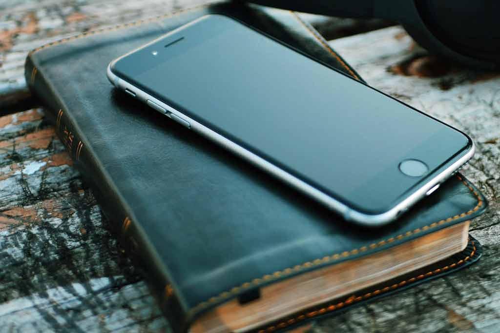 Bible with a smartphone lying on it