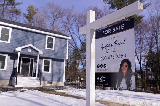 A "For Sale" sign is posted outside a single family home in Derry, N.H.