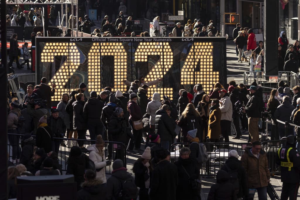 eople gather around the 2024 New Year's Eve numerals displayed in Times Square, Wednesday, Dec. 20, 2023, in New York.